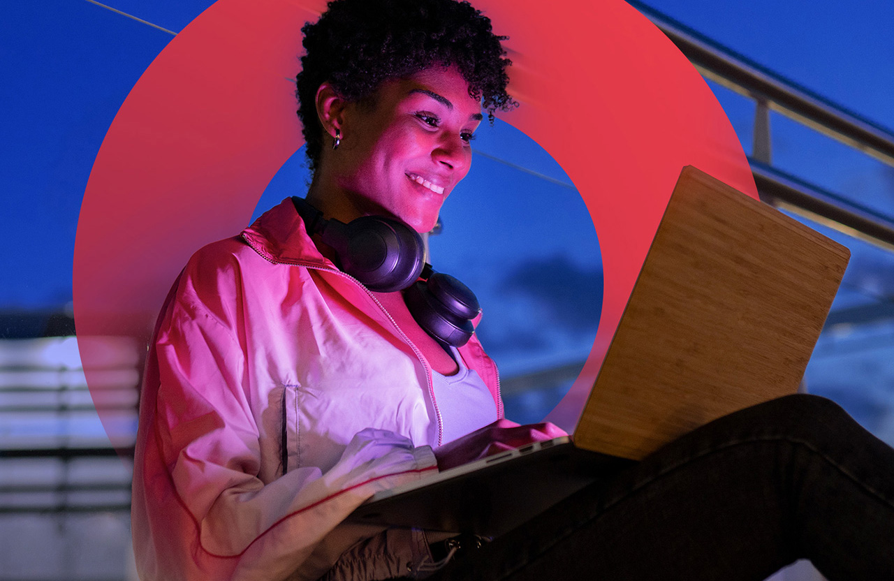 Woman smiling and looking at her laptop