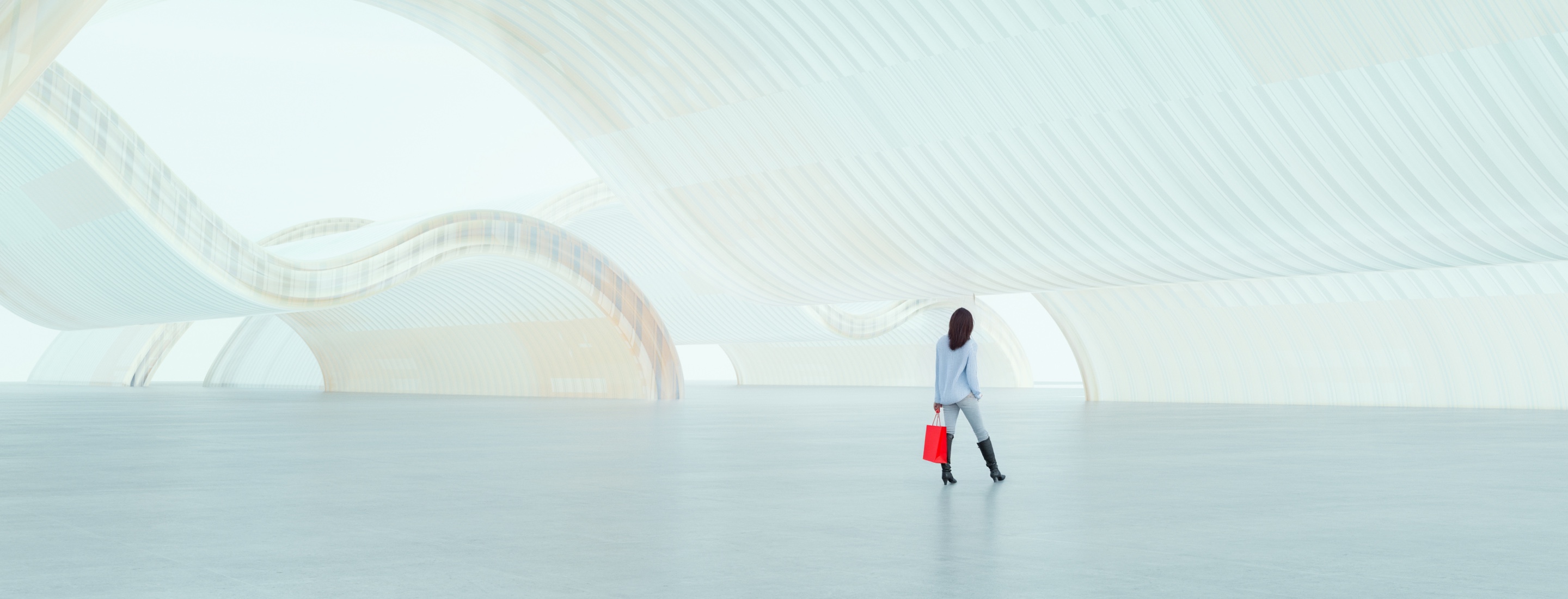 A woman stands holding a bright red shopping back looking around an expansive, abstract environment.