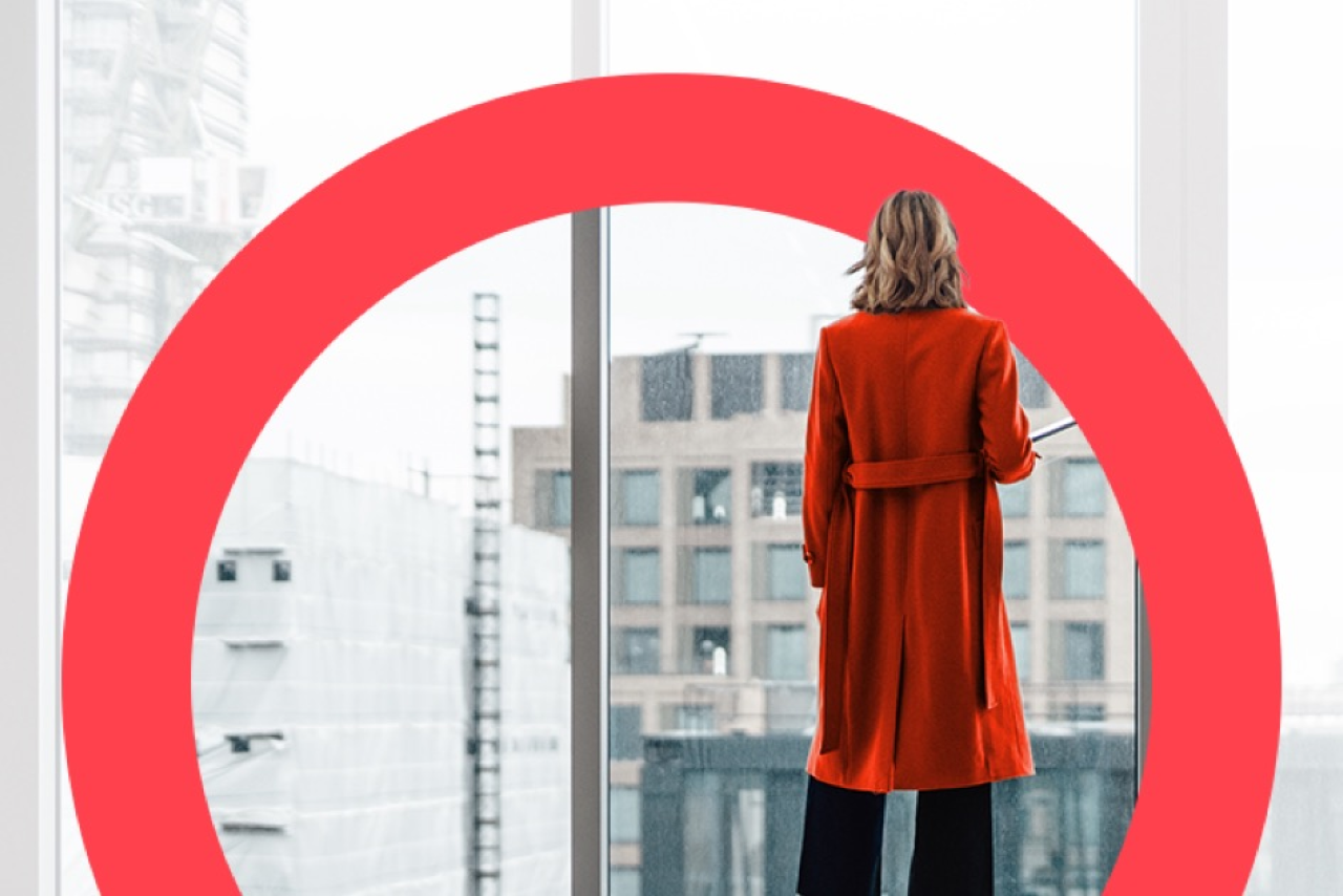 Female professional looking out on cityscape