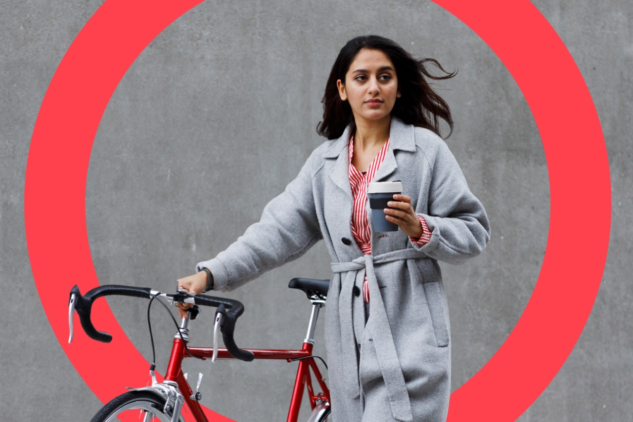 Female professional with coffee and bicycle